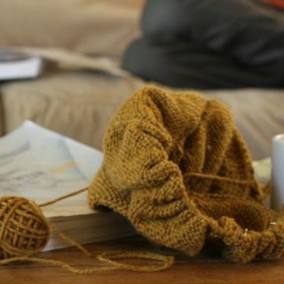 Knitting a barn sweater from taproot and reading Writing With Ease